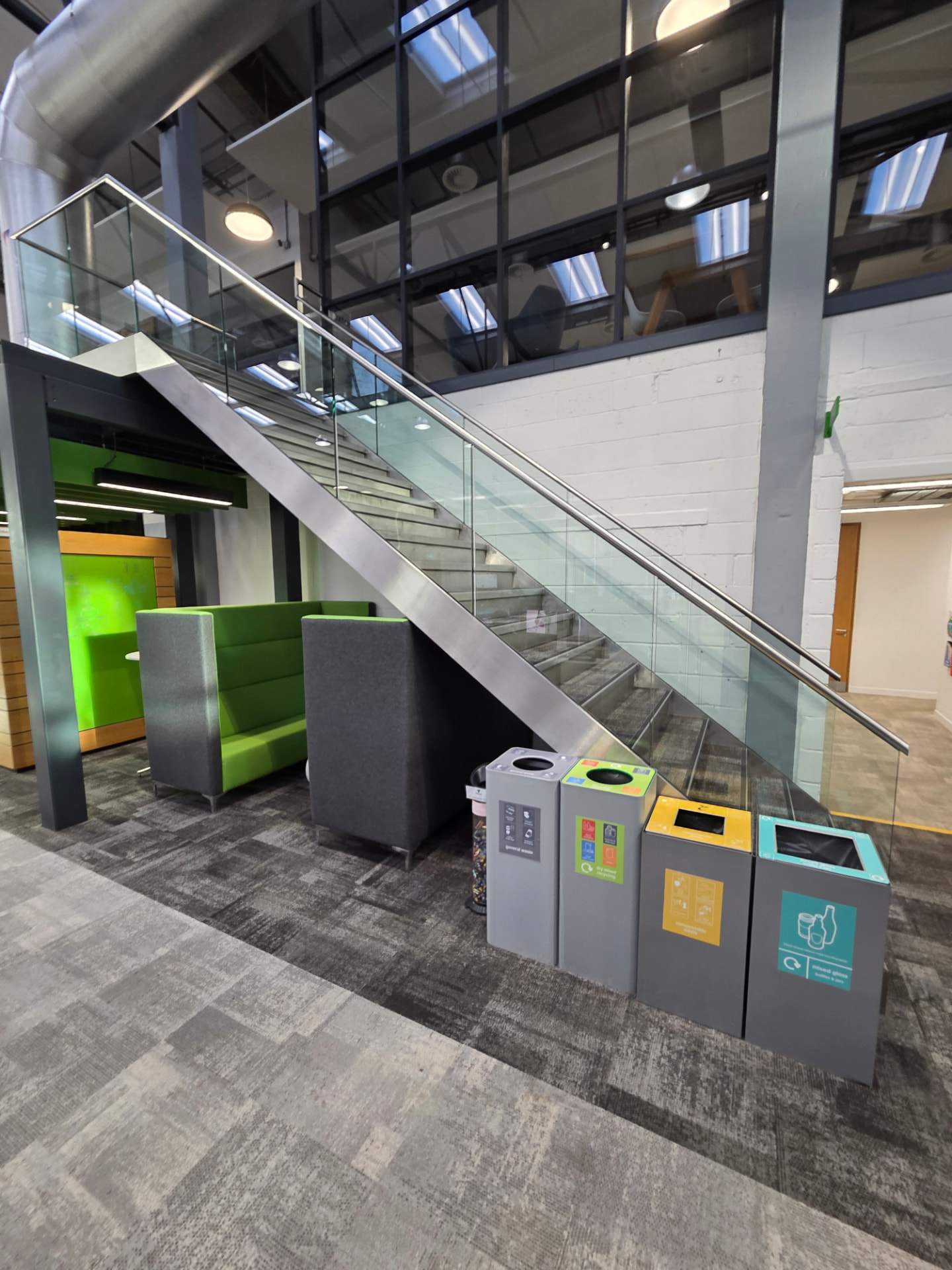 Stainless steel handrail with glass balustrade on a commercial staircase