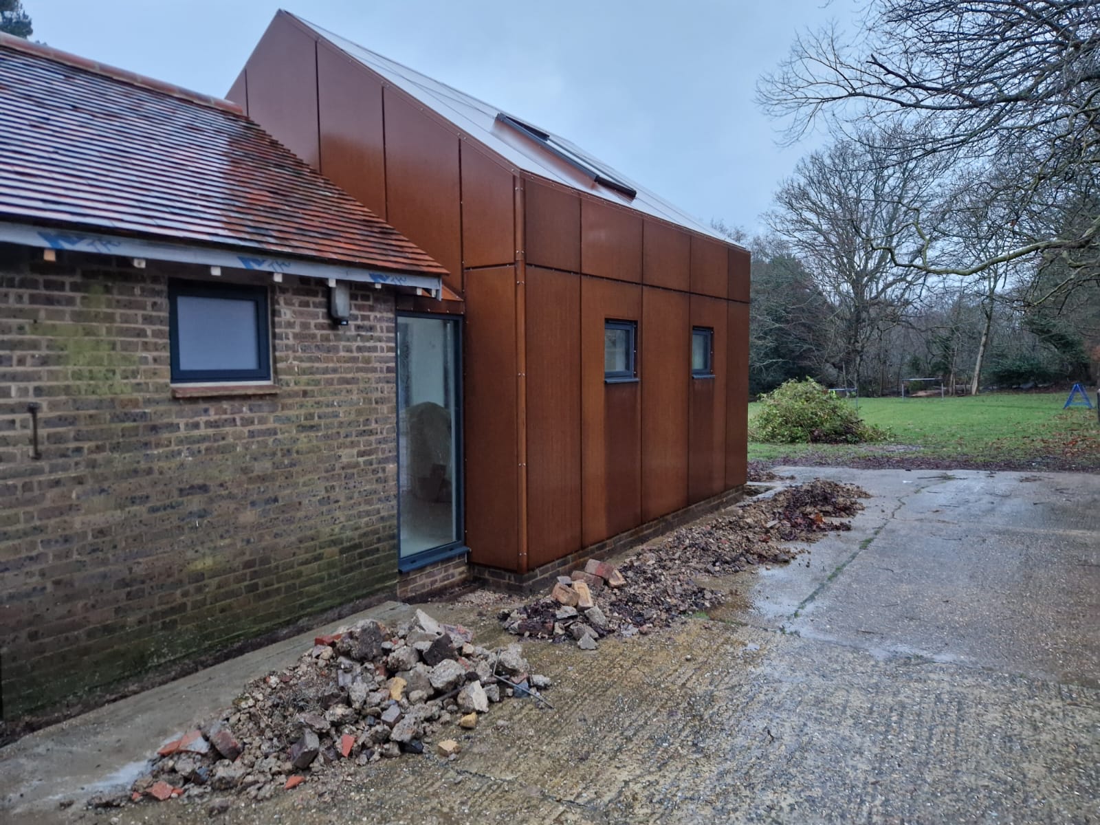 Weathering steel cladding panels installed on an architectural extension